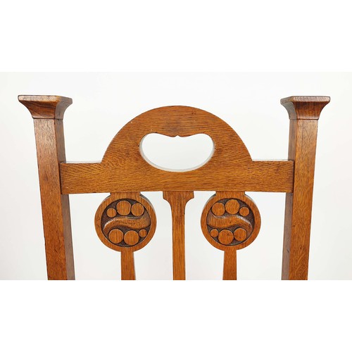 264A - ARTS AND CRAFTS SIDE CHAIRS, a pair, circa 1905 oak the back-splats with carved roundels, overstuffe... 