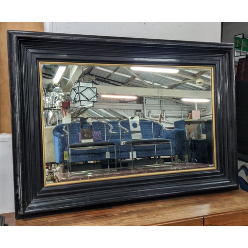 638 - WALL MIRROR, 19th century ebonised with gilt slip, 164cm x 115cm.