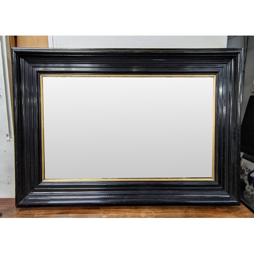 638 - WALL MIRROR, 19th century ebonised with gilt slip, 164cm x 115cm.