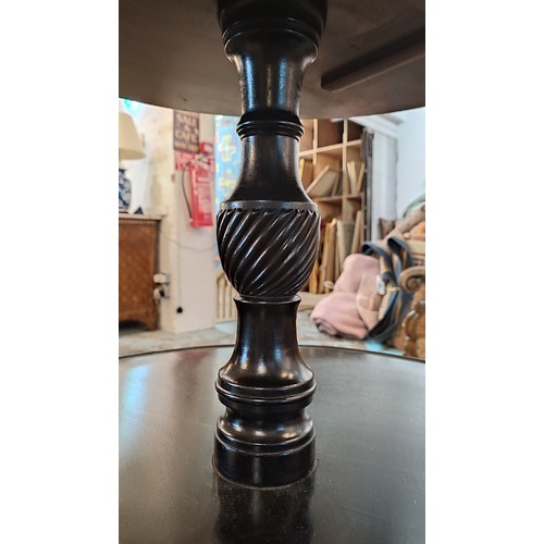 340A - EBONISED DUMB WAITER, 19th century, three-tier each raised on baluster supports, 118cm H x 65cm diam... 