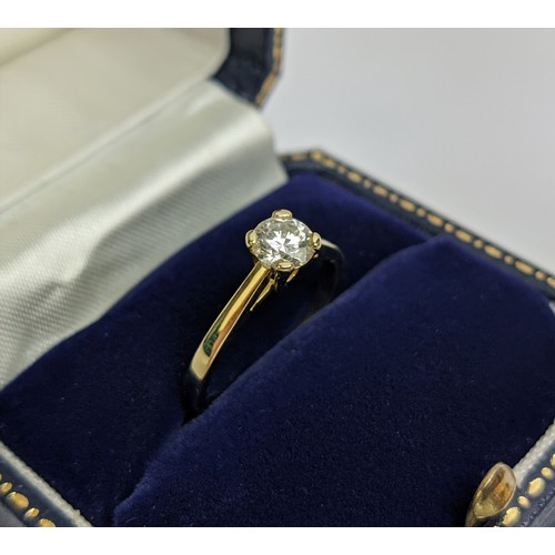 28 - A DIAMOND SOLITAIRE RING, the brilliant cut diamond of approximately 0.50ct, yellow metal shank, cla... 