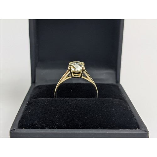 30 - A DIAMOND SOLITAIRE RING, the old mine cut stone of approximately 1.50 carat, yellow metal shank, cl... 