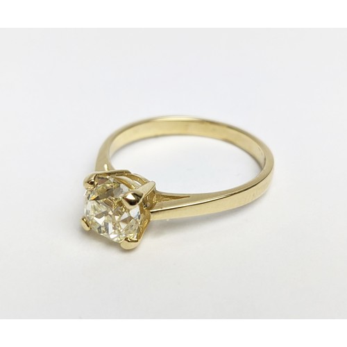 30 - A DIAMOND SOLITAIRE RING, the old mine cut stone of approximately 1.50 carat, yellow metal shank, cl... 