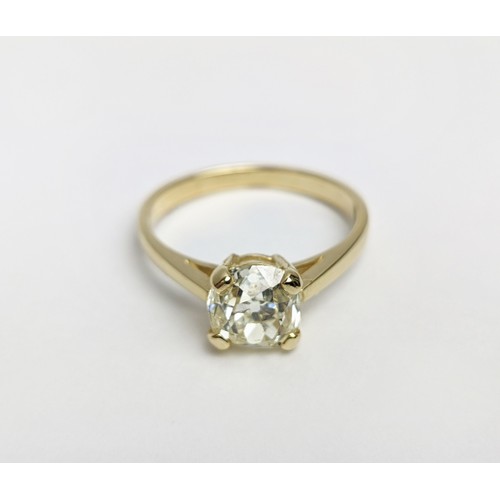 30 - A DIAMOND SOLITAIRE RING, the old mine cut stone of approximately 1.50 carat, yellow metal shank, cl... 