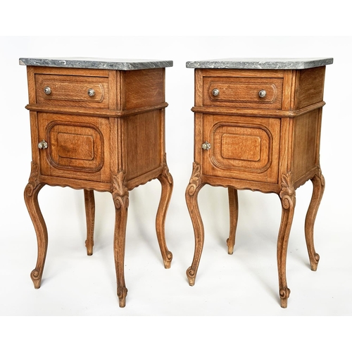 296 - BEDSIDE CABINETS, a pair, 19th century French oak each with drawer and panelled door and St Annes va... 