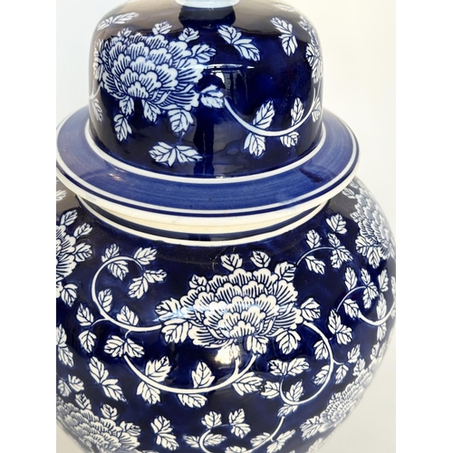 297 - TEMPLE JAR, Chinese white and indigo blue ceramic of lidded vase form, 53cm H.