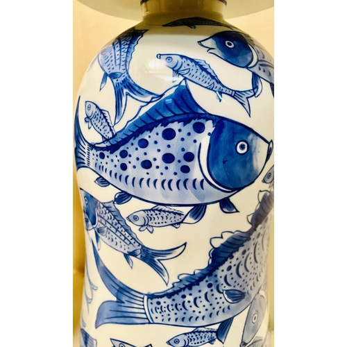 360 - JARS WITH COVERS, a pair, blue and white ceramic with carp decoration, 44cm high, 17cm diam. (2)