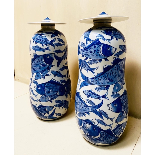 360 - JARS WITH COVERS, a pair, blue and white ceramic with carp decoration, 44cm high, 17cm diam. (2)