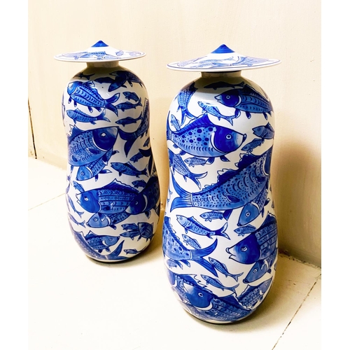 360 - JARS WITH COVERS, a pair, blue and white ceramic with carp decoration, 44cm high, 17cm diam. (2)