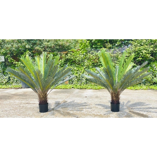 384 - FAUX FERN TREES, a pair, in black planters, 110cm high, 100cm wide. (2)