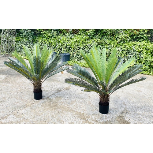 384 - FAUX FERN TREES, a pair, in black planters, 110cm high, 100cm wide. (2)