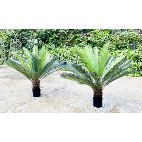 384 - FAUX FERN TREES, a pair, in black planters, 110cm high, 100cm wide. (2)