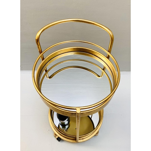 388 - COCKTAIL TROLLEY, 77cm high, 42cm diameter, 1960s French style, mirrored glass tiers, gilt metal fra... 