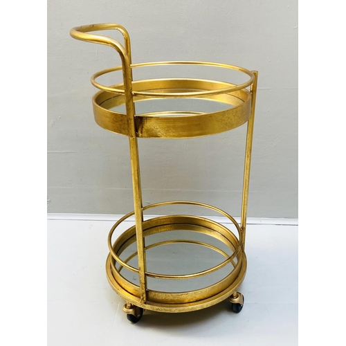 388 - COCKTAIL TROLLEY, 77cm high, 42cm diameter, 1960s French style, mirrored glass tiers, gilt metal fra... 