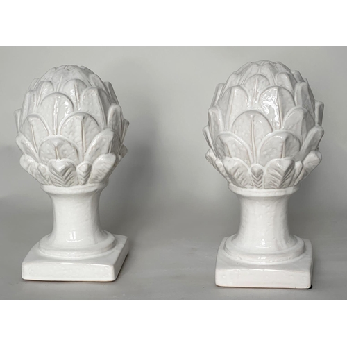 431 - ARTICHOKES, a pair, white ceramic on columns and plinths, 30cm H. (2)