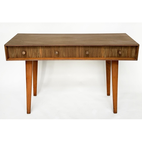 462 - HEALS WRITING TABLE, 1970's teak, concave fronted with three frieze drawers and splay supports attri... 