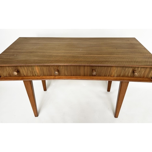 462 - HEALS WRITING TABLE, 1970's teak, concave fronted with three frieze drawers and splay supports attri... 