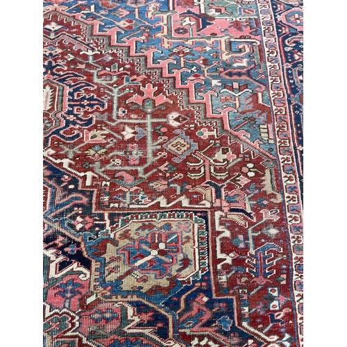 94 - ANTIQUE PERSIAN HERIZ CARPET, 345cm x 245cm.