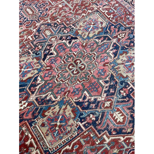 94 - ANTIQUE PERSIAN HERIZ CARPET, 345cm x 245cm.