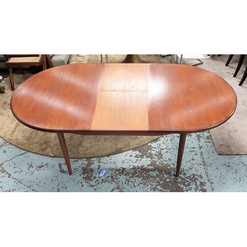 357 - G PLAN EXTENDING DINING TABLE, 1970s, teak, the top sliding out reveal extra leaf, raised on turned ... 