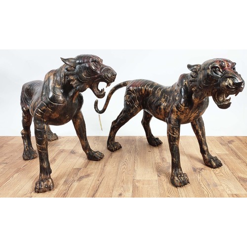 503 - SCULPTURAL TIGERS, a pair, cast metal. 62cm high, 120cm wide, 40cm deep (2)