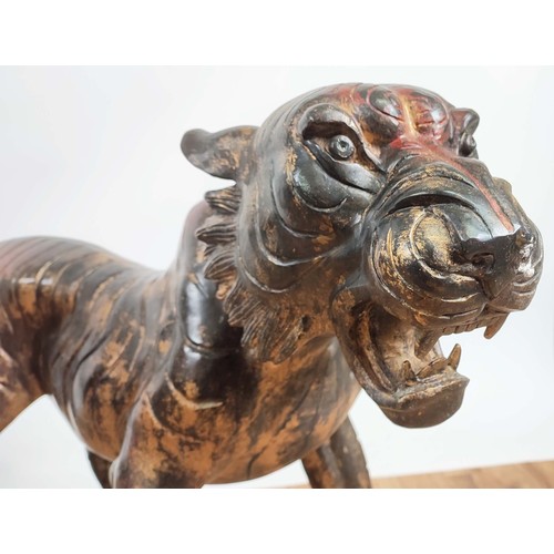 503 - SCULPTURAL TIGERS, a pair, cast metal. 62cm high, 120cm wide, 40cm deep (2)