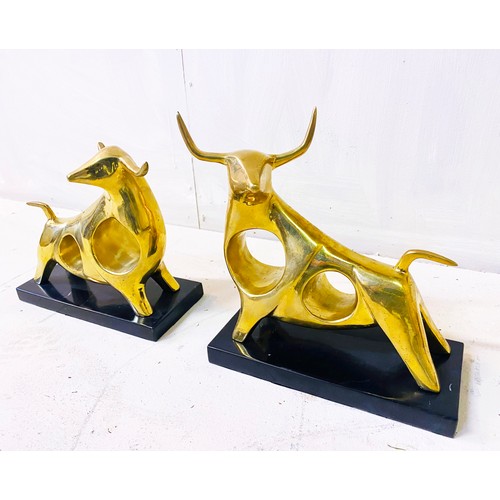 509 - SCULPTURAL CAST BRONZE BULLS, a set of two, each raised on black marble bases, 19cm high, 25cm wide,... 