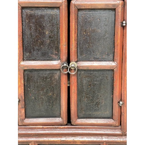 161 - CHINESE CABINET, 19th century scarlet firwood framed enclosing faint gilt decorated black lacquer pa... 