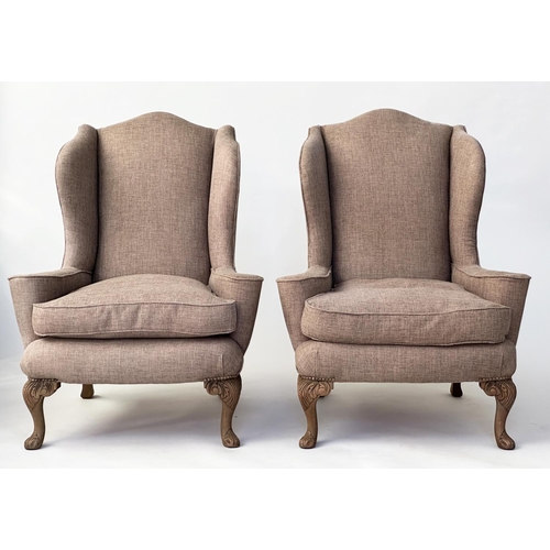 106 - WINGBACK ARMCHAIRS, a pair, Queen Anne style with natural linen upholstery and carved walnut cabrile... 