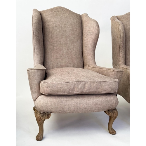 106 - WINGBACK ARMCHAIRS, a pair, Queen Anne style with natural linen upholstery and carved walnut cabrile... 