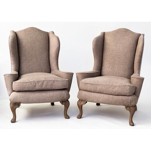 106 - WINGBACK ARMCHAIRS, a pair, Queen Anne style with natural linen upholstery and carved walnut cabrile... 