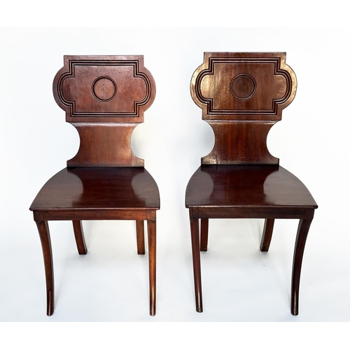 121 - HALL CHAIRS, a pair, Regency style mahogany with cartouche inset backs and sabre front supports, 44c... 