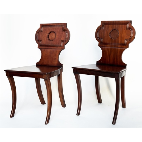 121 - HALL CHAIRS, a pair, Regency style mahogany with cartouche inset backs and sabre front supports, 44c... 