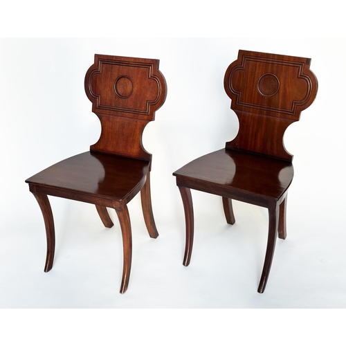 121 - HALL CHAIRS, a pair, Regency style mahogany with cartouche inset backs and sabre front supports, 44c... 