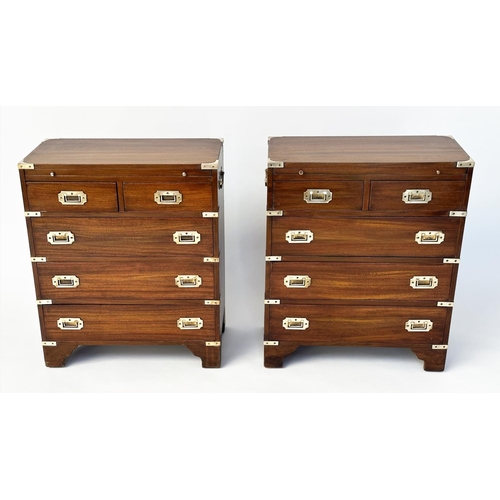 122 - CAMPAIGN STYLE CHESTS, a pair, mahogany and brass bound each with brushing slide above two short and... 