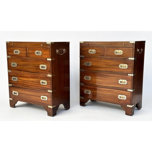 122 - CAMPAIGN STYLE CHESTS, a pair, mahogany and brass bound each with brushing slide above two short and... 