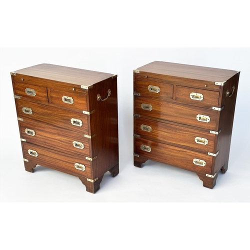 122 - CAMPAIGN STYLE CHESTS, a pair, mahogany and brass bound each with brushing slide above two short and... 