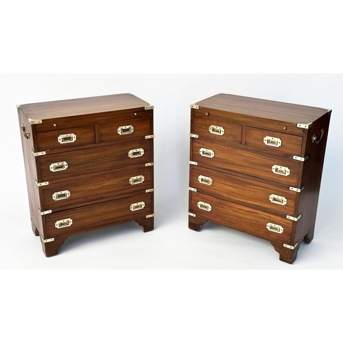 122 - CAMPAIGN STYLE CHESTS, a pair, mahogany and brass bound each with brushing slide above two short and... 