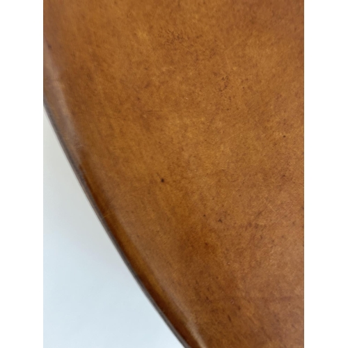 125 - CENTRE STOOL, circular stitched mid brown, natural leather with bun supports, 100cm W x 31cm H.