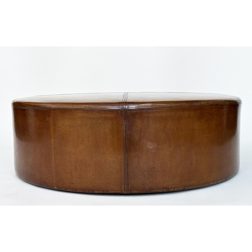 125 - CENTRE STOOL, circular stitched mid brown, natural leather with bun supports, 100cm W x 31cm H.