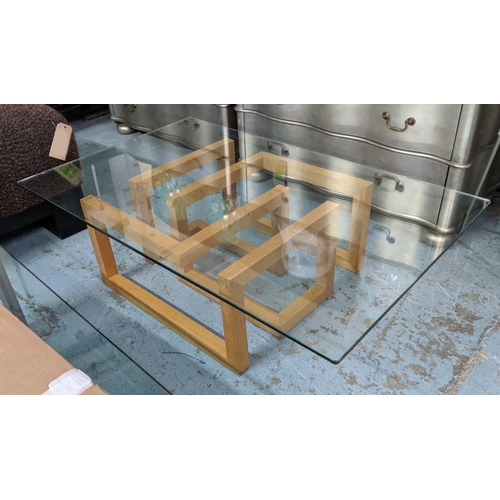 376 - LOW TABLE, glass top, geometric wooden base, 85cm x 135L x 38cm H.