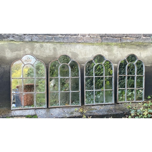 405 - ARCHITECTURAL GARDEN MIRRORS, a set of four aged metal frames, 61cm x 39cnm. (4)