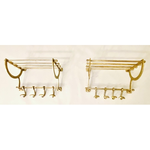 406 - WALL MOUNTING LUGGAGE RACKS, a pair, each with a rodded rack and four hooks, gilt metal, 35cm high, ... 