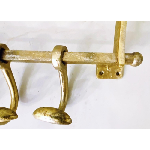 406 - WALL MOUNTING LUGGAGE RACKS, a pair, each with a rodded rack and four hooks, gilt metal, 35cm high, ... 