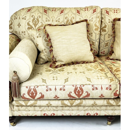 87 - SOFA, traditional style, three seater with ottoman design fabric, raised on six turned legs and bras... 