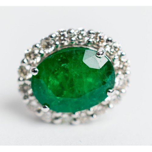 519 - A PAIR OF 18CT WHITE GOLD EMERALD AND DIAMOND STUD EARRINGS, the central emerald stones of 2.76 cara... 