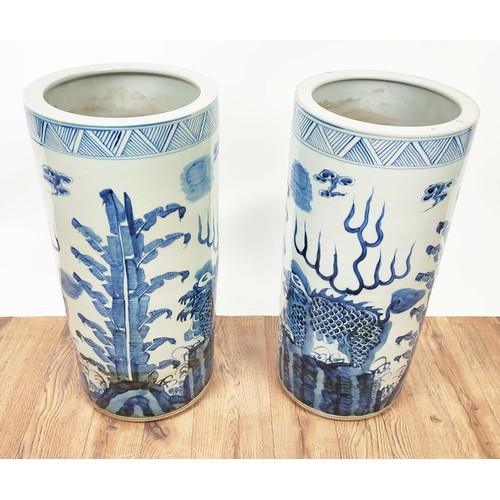 392 - STICK STANDS, a pair, Chinese export style blue and white ceramic, 60cm H x 20cm diam approx. (2)