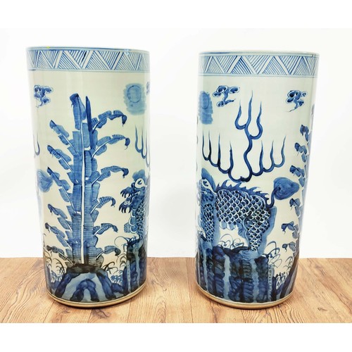 392 - STICK STANDS, a pair, Chinese export style blue and white ceramic, 60cm H x 20cm diam approx. (2)