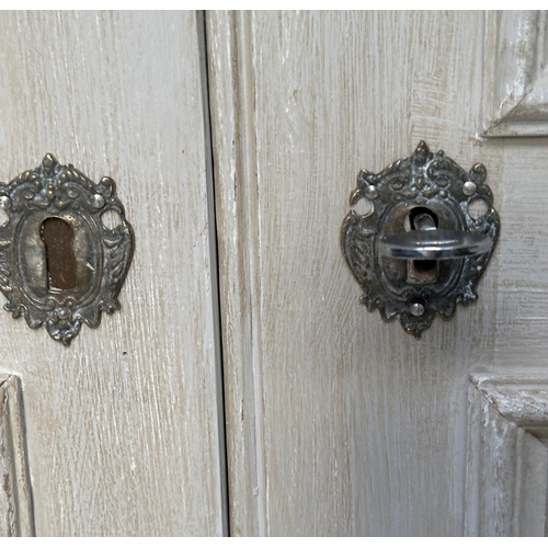 137 - ARMOIRE, French style traditionally grey painted with two panelled doors, enclosing hanging space ab... 