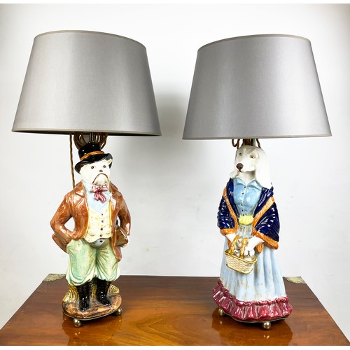 1 - FIGURAL LAMPS, a pair, dog caricatures modelled as a country squire and a shawled lady in multi colo... 